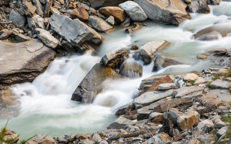 some rocks and a white river flowing