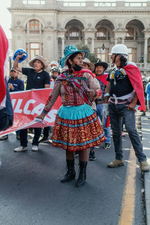 women in a dress and hats standing on the street