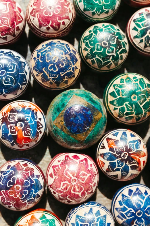 colorful painted balls with various patterns on the tops