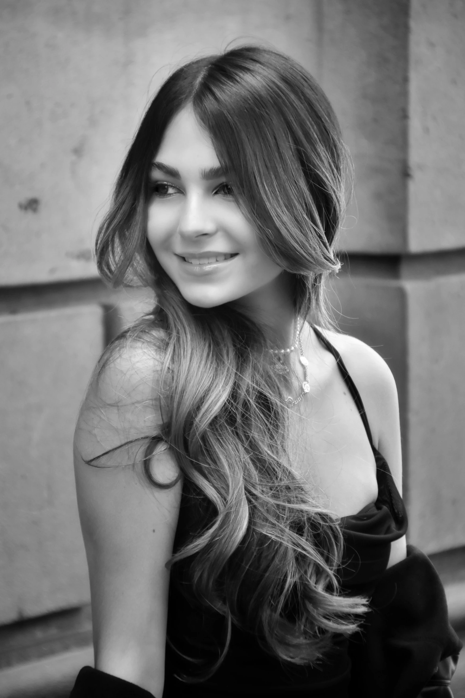 a woman sitting and posing with her hair long