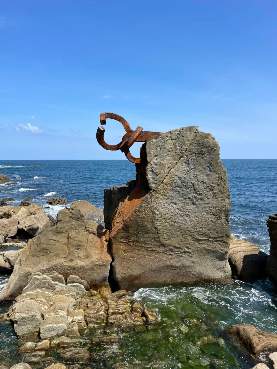 two circles on rocks in front of the ocean