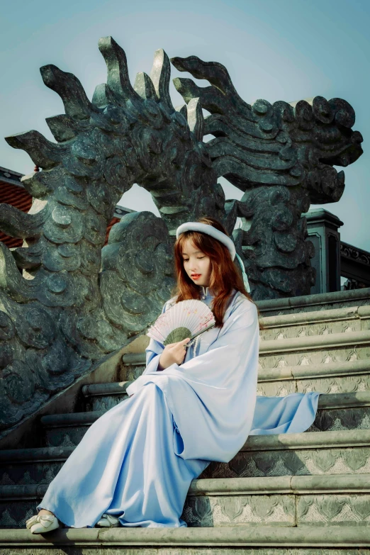 a woman in blue sitting on stairs