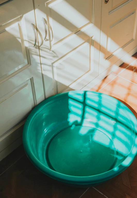 a bowl is sitting next to a white cupboard