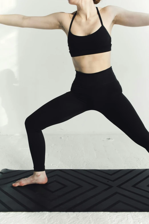 a woman in a yoga outfit doing a lung exercise