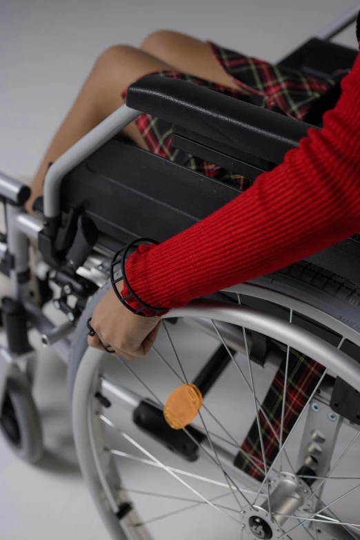 someone's hand on the wheel of a wheelchair