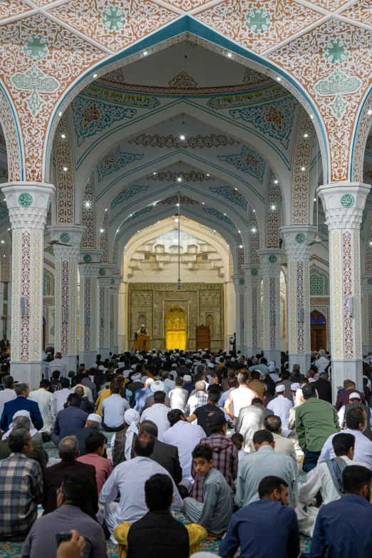 a large group of people sitting in the middle of a church