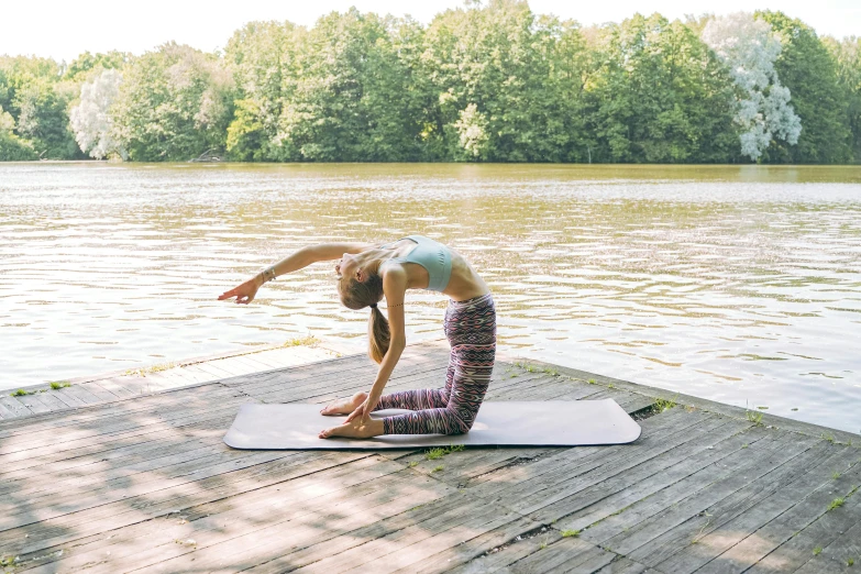 woman doing a side splits on a yoga mat