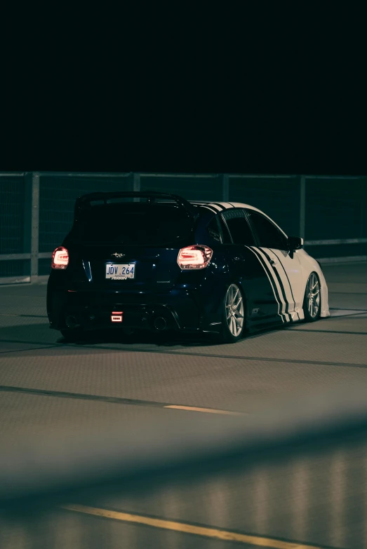 a car is shown with its hood on while being driven at night