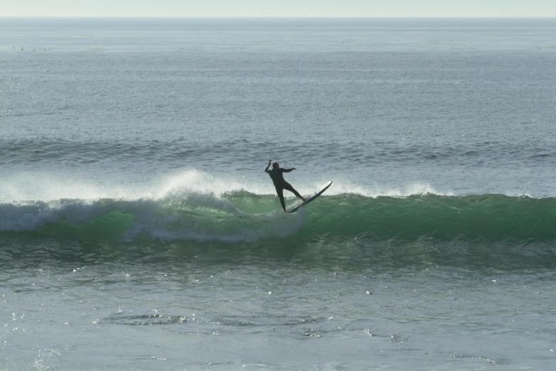 a man on a surfboard riding a wave in the ocean