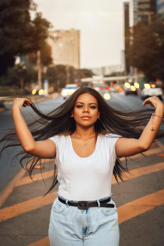 a woman poses in the middle of a busy street