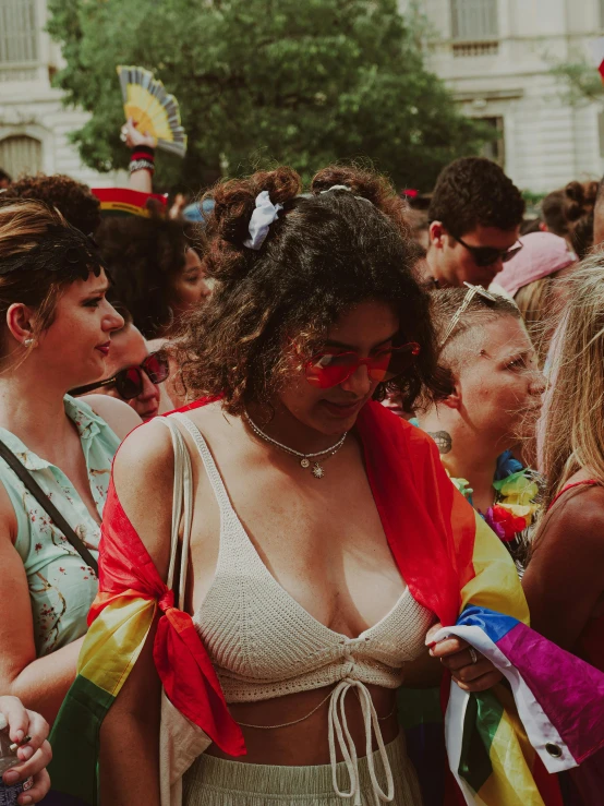 a woman with her shirt open and some women in red scarves