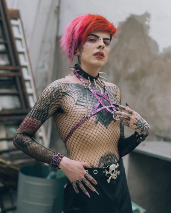 man with colorful hair wearing fishnet clothes and gloves