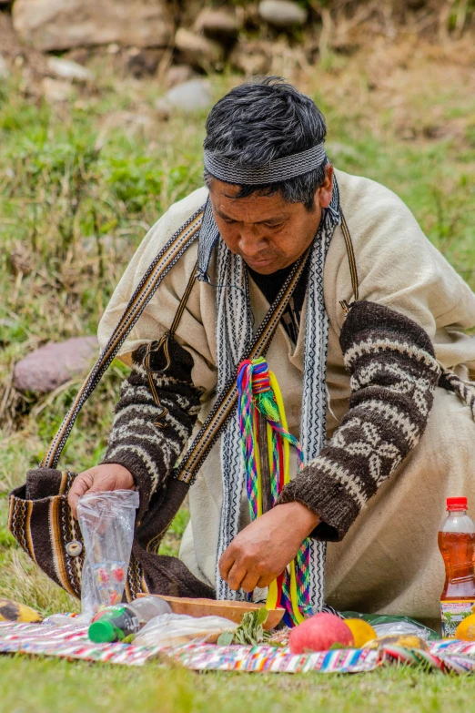 a man that is sitting in the grass