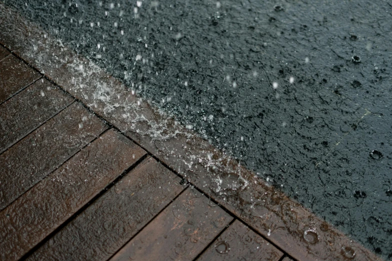 the ground and sidewalk are covered with rain