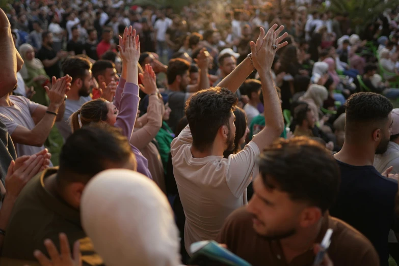 group of people with arms up in the air