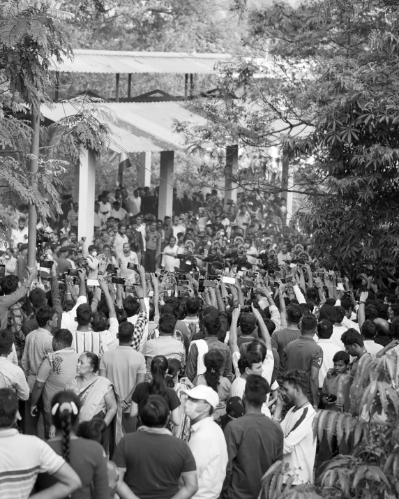 there are people standing in a group outside and waving