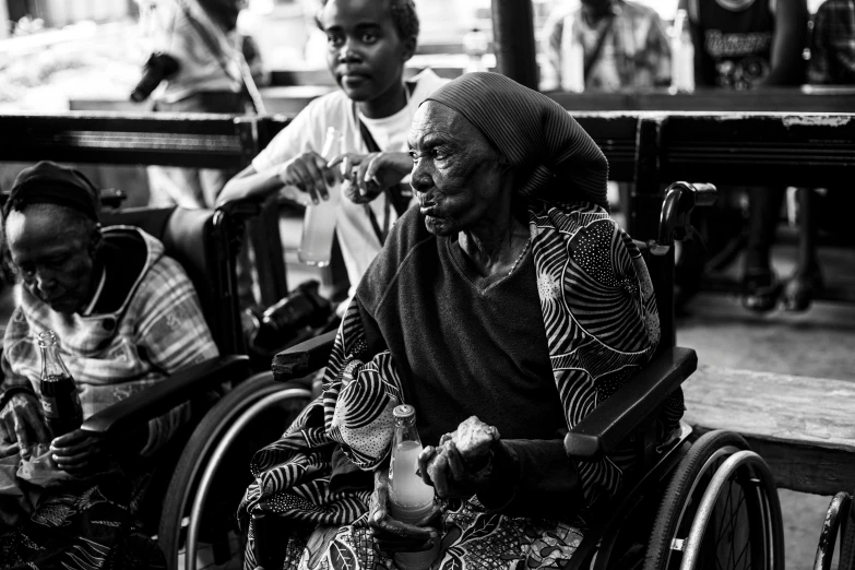 a group of people sit in wheelchairs