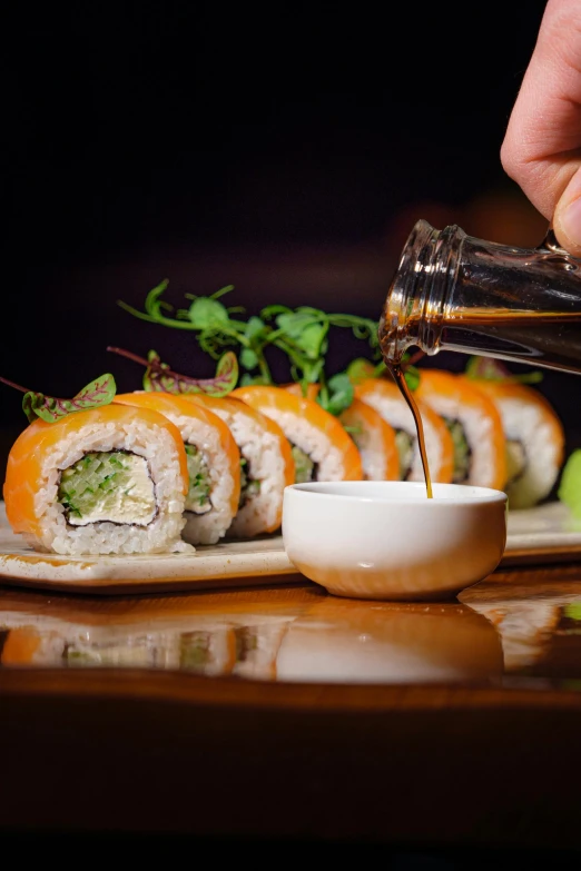 sushi roll on plate being filled with sauce