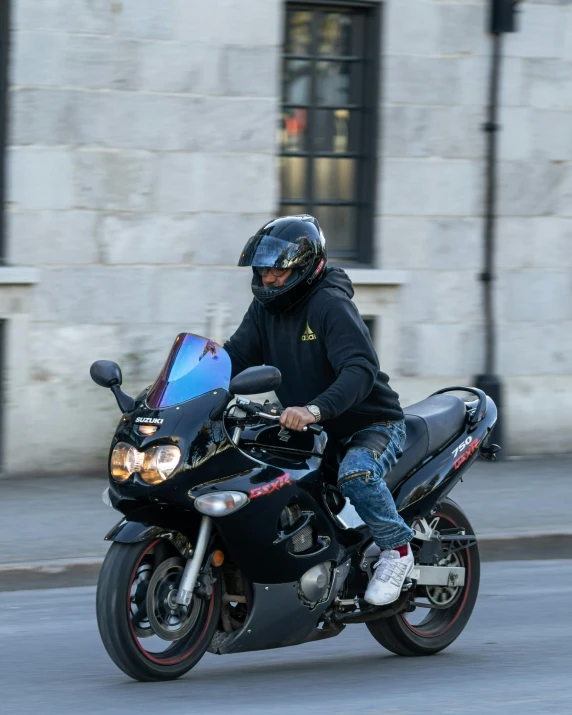 the person rides a motorcycle with a helmet on