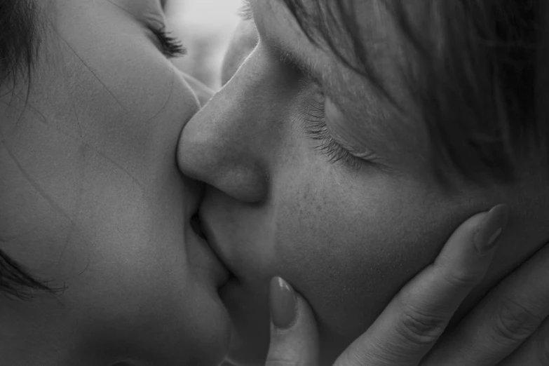 a woman kissing a baby on the nose