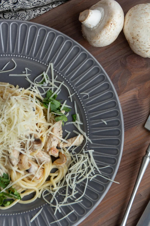 the pasta is served on the plate with mushrooms