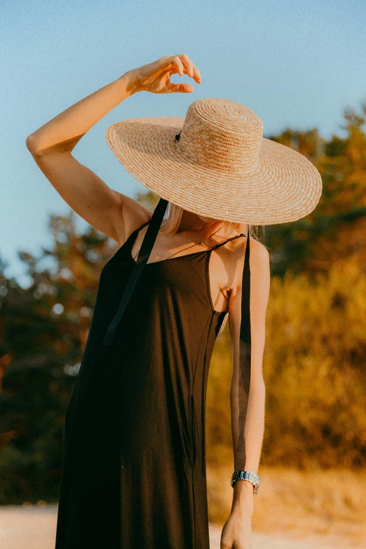 a person in a hat walking along the road