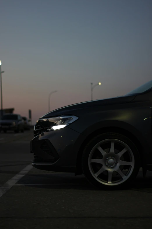 an evening s of a parked car in the parking lot