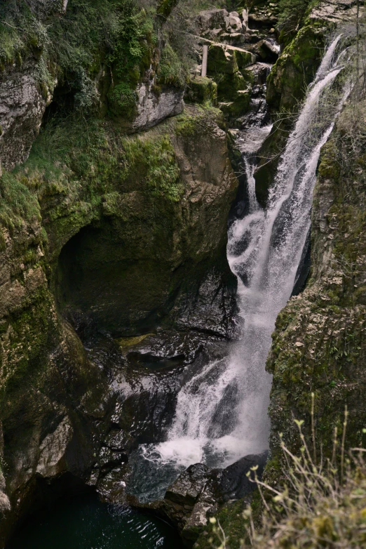 a couple of waterfalls are running over rocks