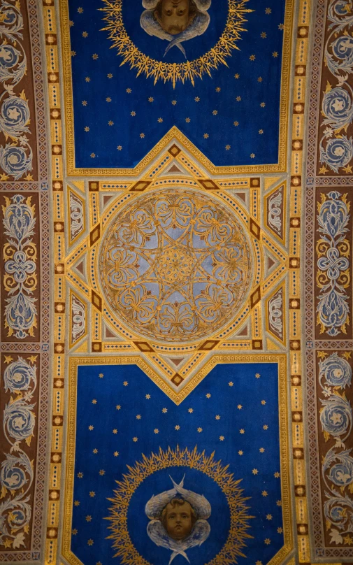 the ceiling in a hall has decorative designs