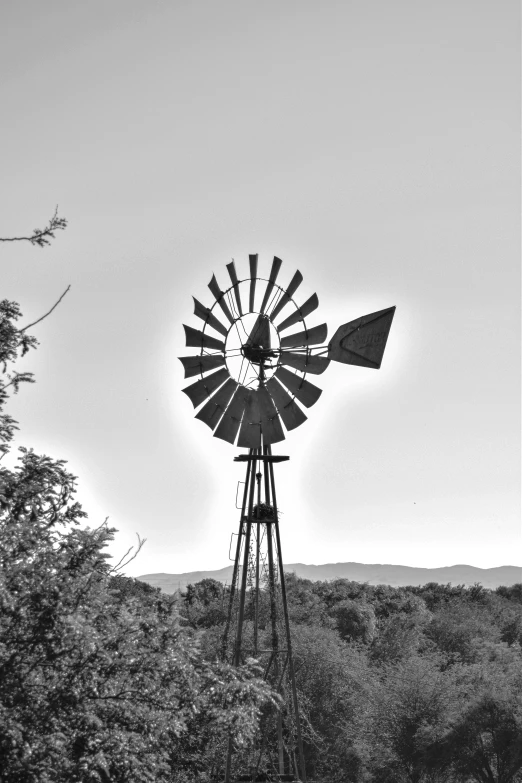 an old windmill in a grassy field