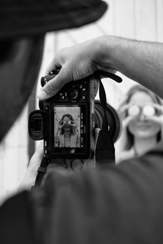 a person that is holding a camera in their hands