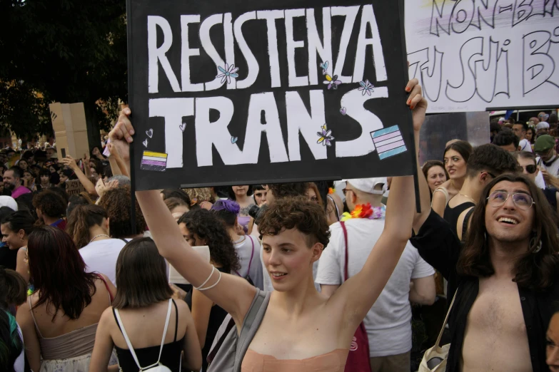 several people gathered with signs saying resistance transs