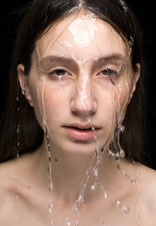 a woman with her face covered in water