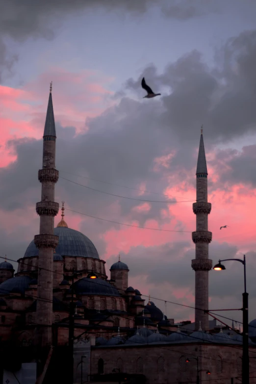 a mosque is shown in the evening as the sun goes down