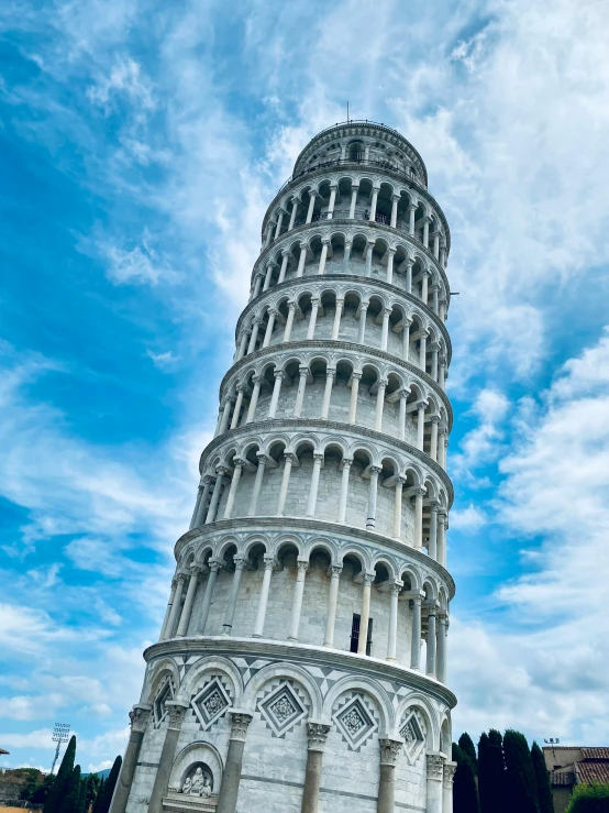 the large leaning tower has multiple statues on it