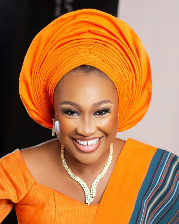 an african american woman in an orange dress