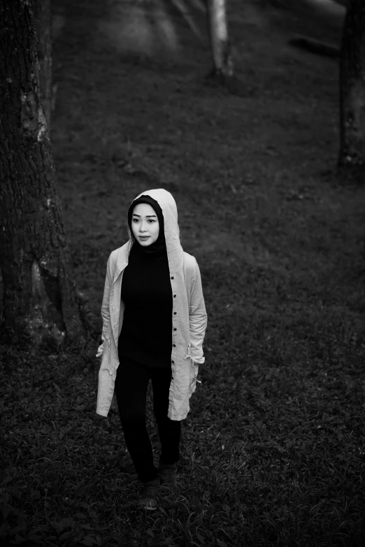 black and white po of woman walking in the woods