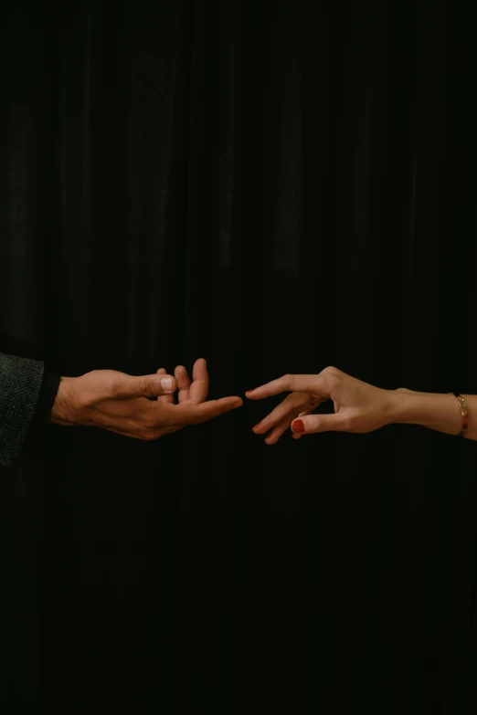 two hands reaching out towards each other