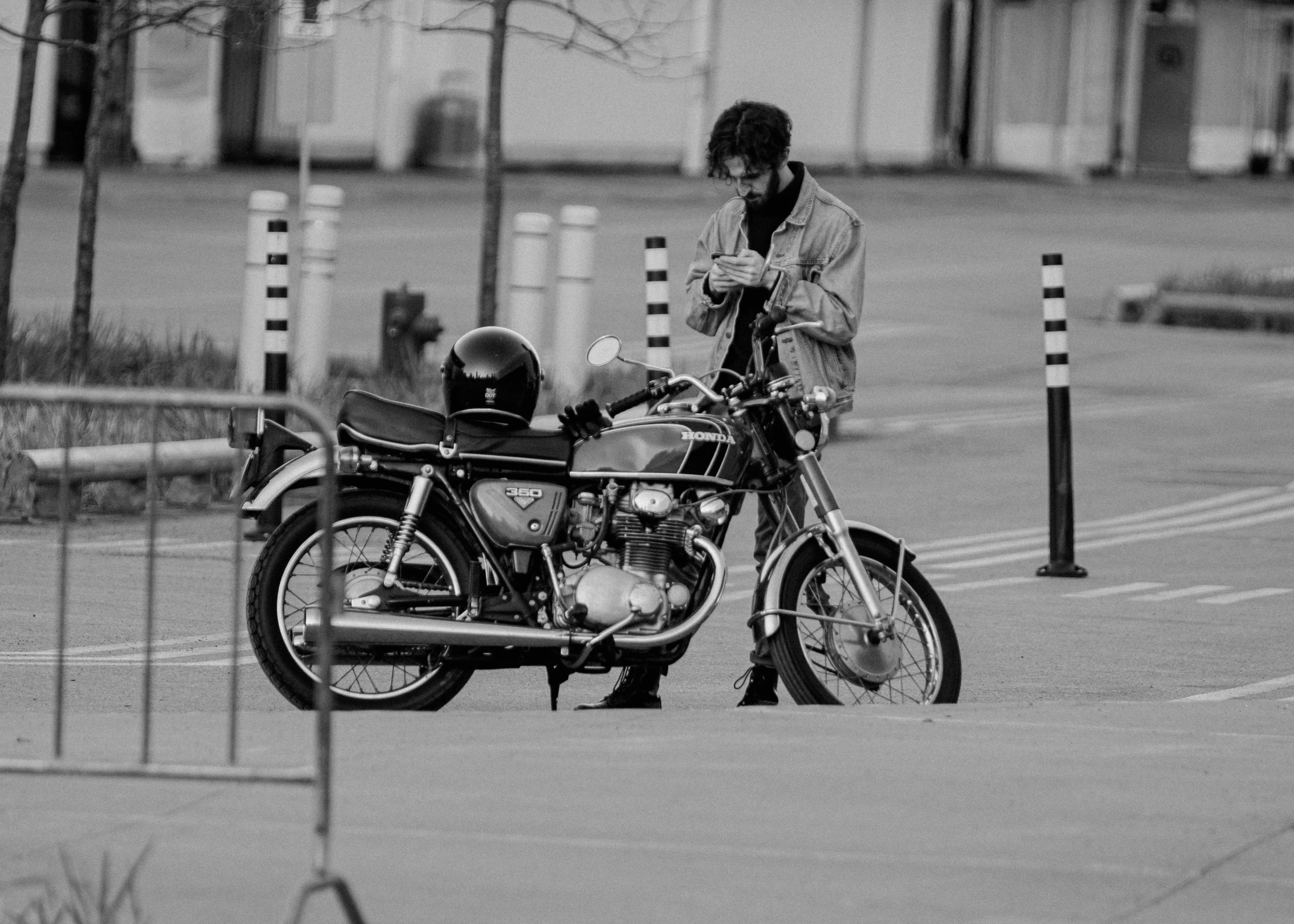 a man standing next to a parked motorcycle