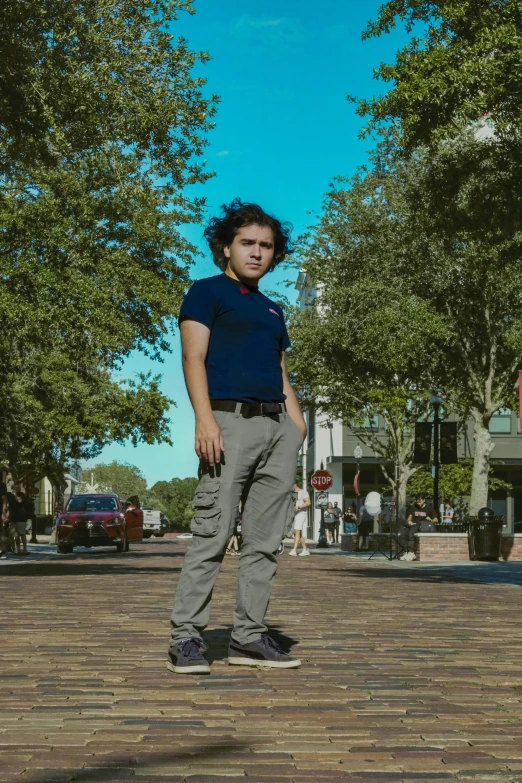 a woman stands on her skateboard in a brick plaza