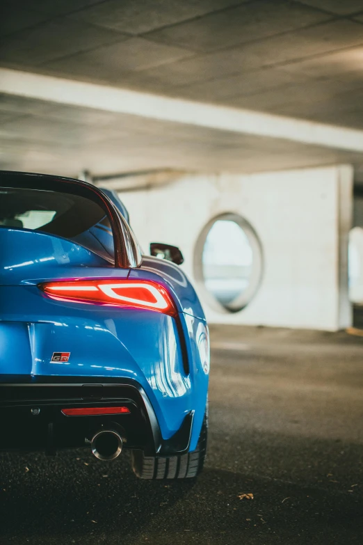 the rear end of the sports car parked in the parking lot