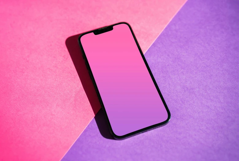 a phone is shown in front of the pink screen