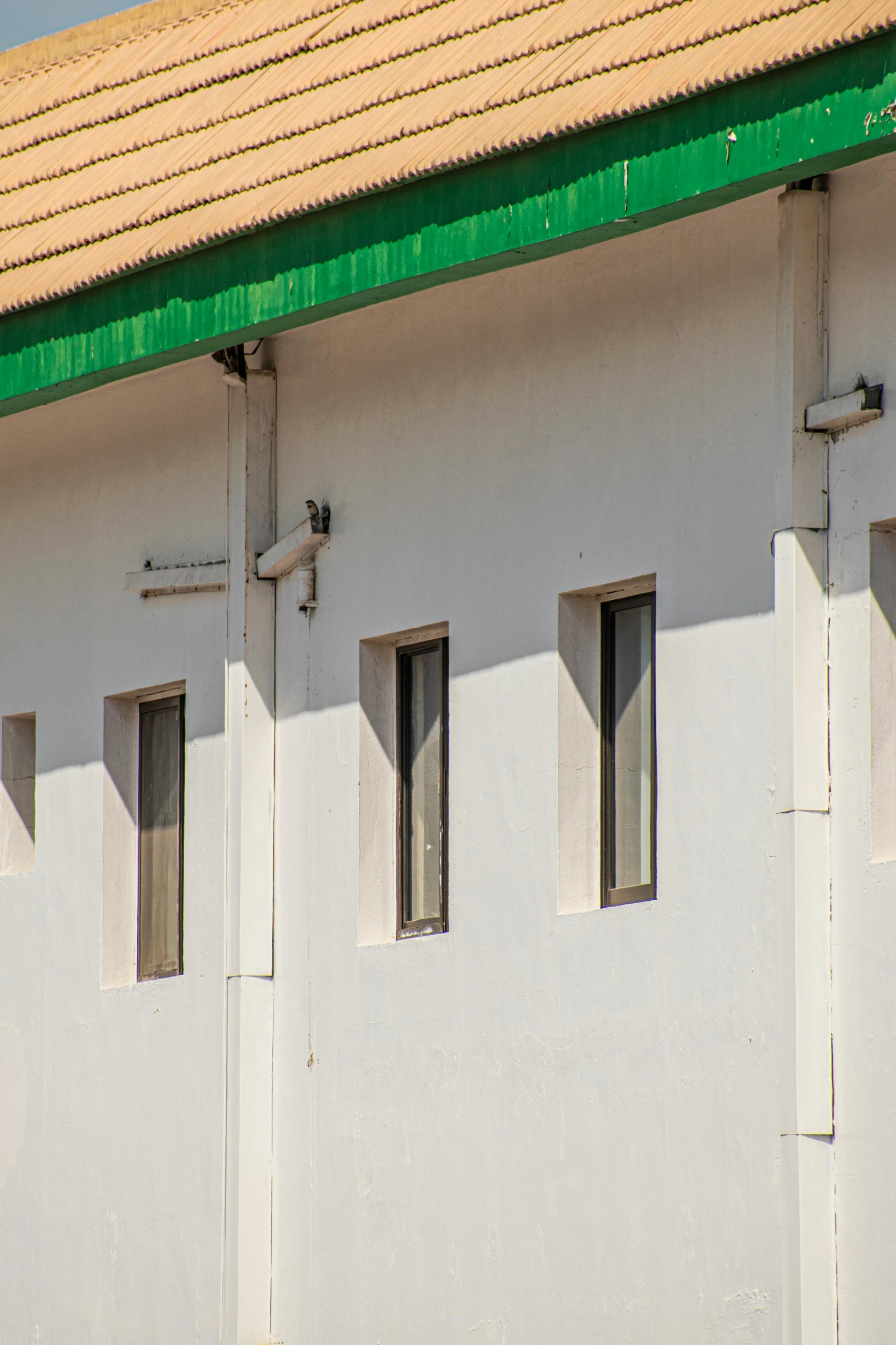 a white building with green trim and windows