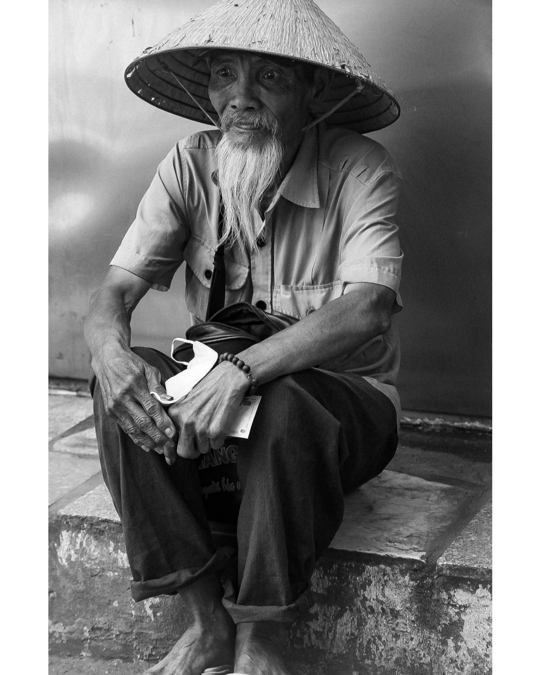 a black and white po of an old man with a hat on
