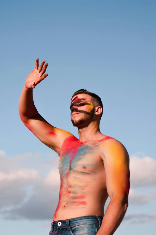 man with body and face paint posing for camera