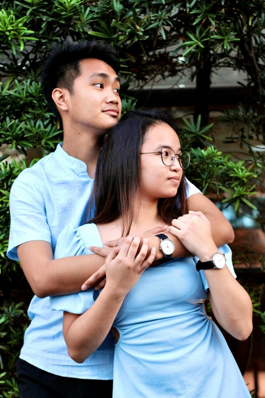 a woman in a blue dress and a man in a blue shirt