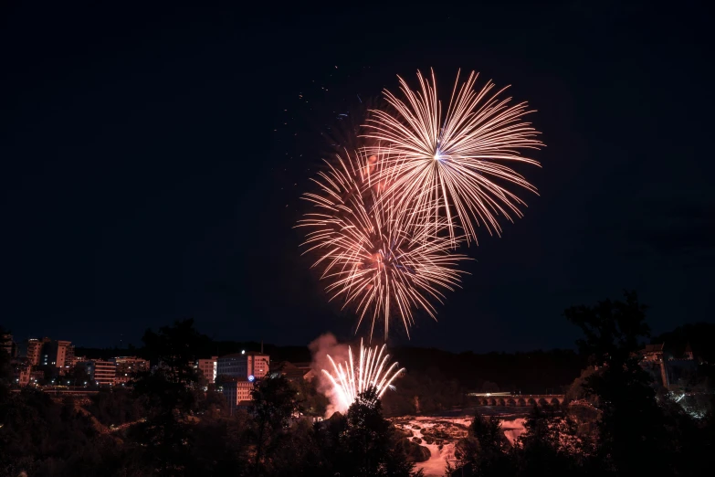 firework display in night sky over the city