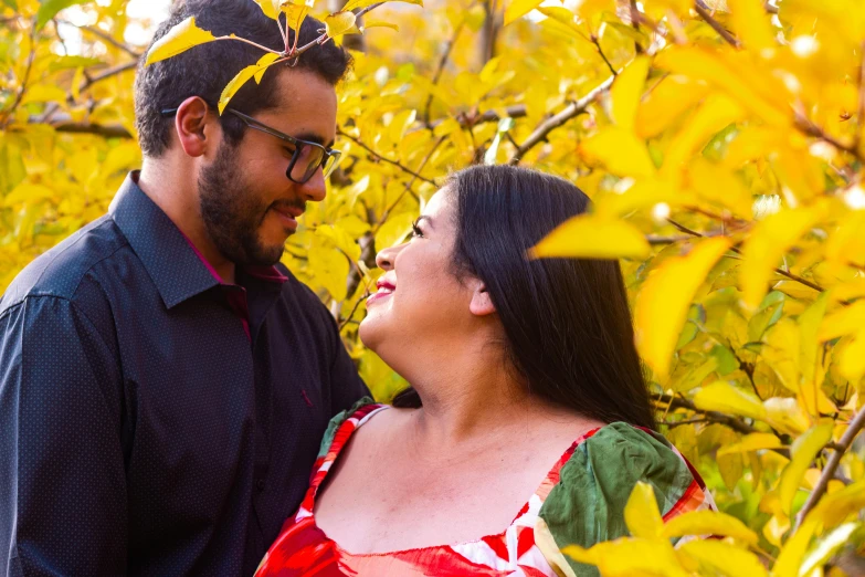 an image of a man and woman that are standing in the grass