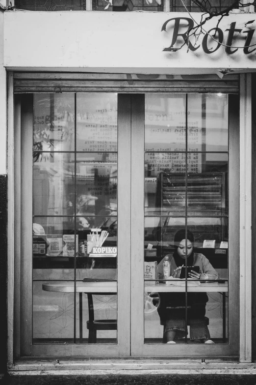 a couple of people sitting at a table outside of a building