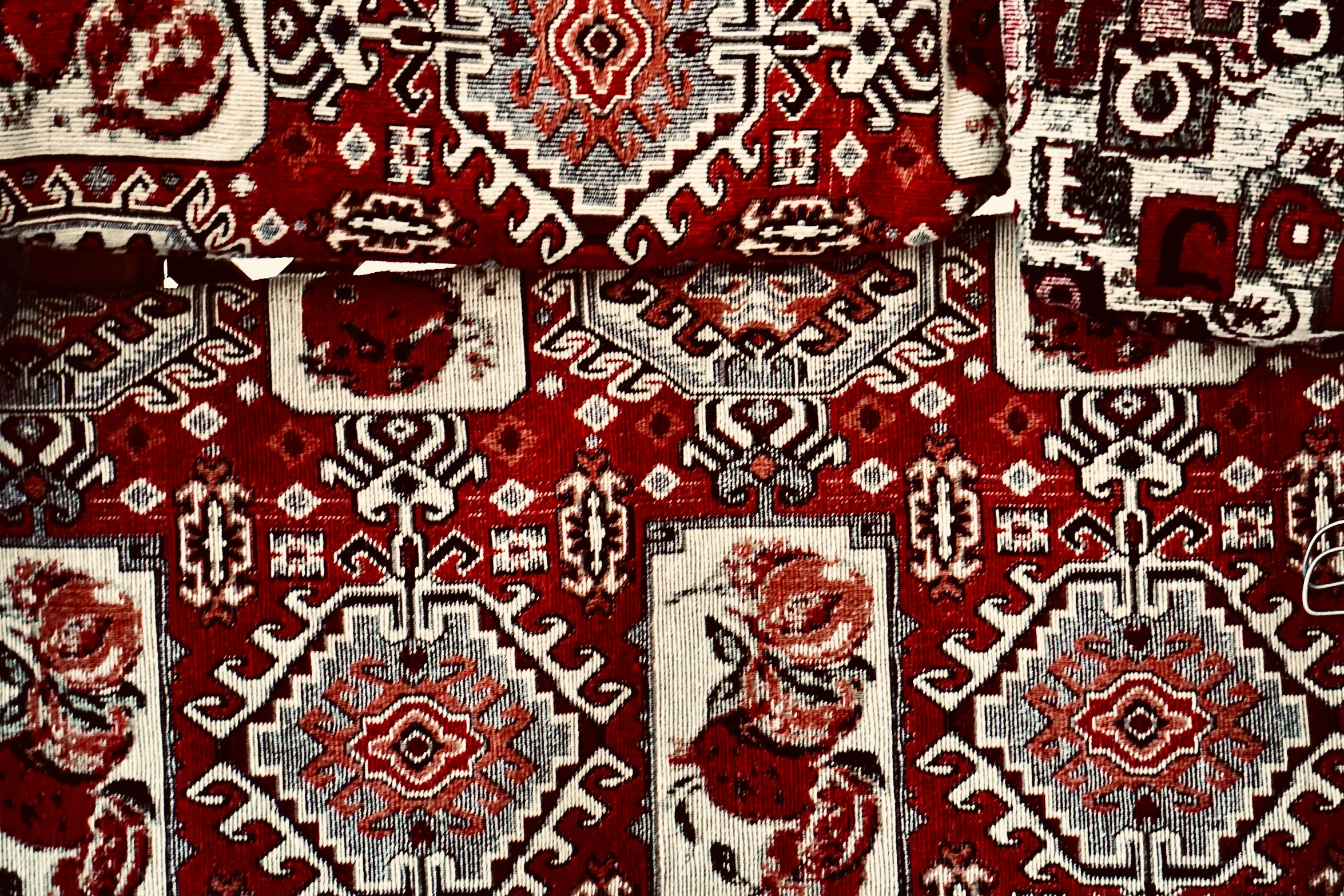 the large red rug with the pattern on it